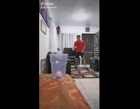 Guy throws paper balls into plastic cup