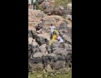 Pregnant woman in yellow dress kissed stomach by husband