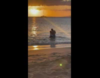 Couple photo shoot beach waves sunset boat