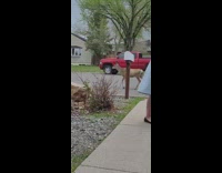 Woman with cat points at deer 