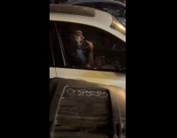 Guy shaves beard inside car street parking