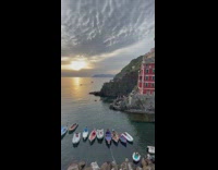 Canal connected to ocean Italy sunset boats