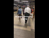 Spiderman plays drum bongos on bench in subway station