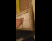 Guy scrape off ice in air conditioner