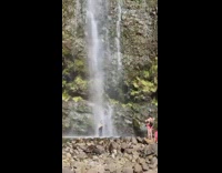 Guy tank top pose under waterfalls nature