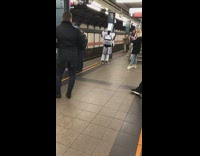 Robot transformers costume made out of beer boxes subway platform
