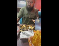 Guy wraps food in tortilla 