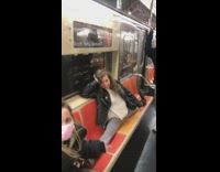 Female dancer does splits on subway seats 