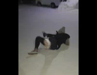 girl in all black slips on snow doesnt drop drink