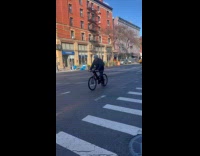 Man in Santa costume riding bike 