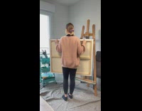 Woman shows ocean painting 