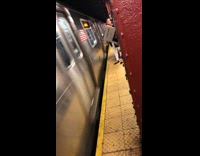 Passenger waits for subway train and reads book called I love dick in station
