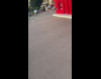 Woman black top pose behind #ILoveNice sign