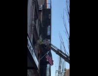 Santa and Elf on crane of firetruck