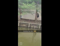 Red sweater guy films music video water