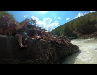 Guy struggles to paddle against current in kayak 