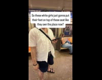 Woman sits with feet on train seat