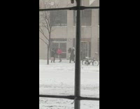 Guy uses umbrella as shield during snowstorm 