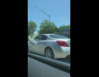 Driver on freeway sticks foot out of window 