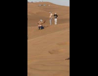 Photographer kneels and reveals its butt crack