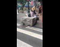 Woman sings guy does headstand on street