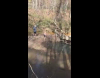 Guy runs and flips over onto the other side of the river successfully 