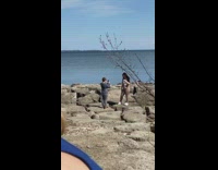 Woman crop top shore brother takes photo