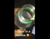 Cigarette bud lands in middle of bottle