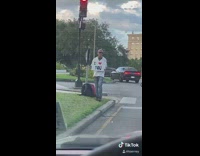 Guy holds white i love you sign 