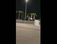 White jacket guy poses ground water fountain 