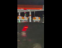Group of people dances beside the car at the gasoline station