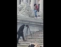 Man pink coat lion statue stairs Microsoft