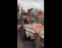 Rundown car with graffiti parked on street 