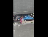 Woman red pajama tiktok dance windy rooftop