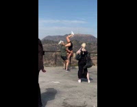 Collab IITW - Man carries woman upside down for photo hollywood sign 