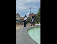 Two Woman Film Dance next to Fountain 