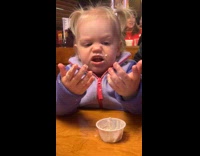 Girl eats and spread butter on face