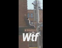 Boy climbs and sits on awning in front of sunglass hut store