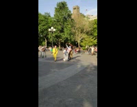 2 guys roll on ground attached to each other to music 