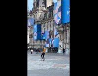 Collab IITW - Man brown jacket tiktok dance at park blue paris billboard behind