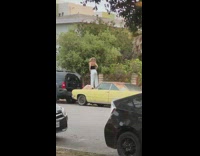Girl tube stand over neighbor yellow car