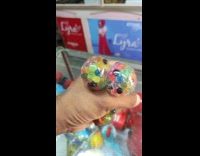 Man squeezes colorful stress ball 