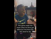 Girl watches younger brother play video games