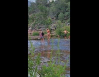 Red bikini lady stands poses water hike 
