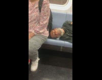 Guy lays on train seats close to stranger 