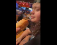 Guy airplane feeds friend bread 