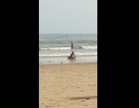 Guy lay on beach use seflie stick