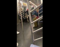 Guy trims beard with scissors on subway