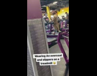 Girl wearing brown coat exercises on treadmill 