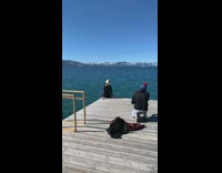 Woman sits with view of Lake Tahoe 